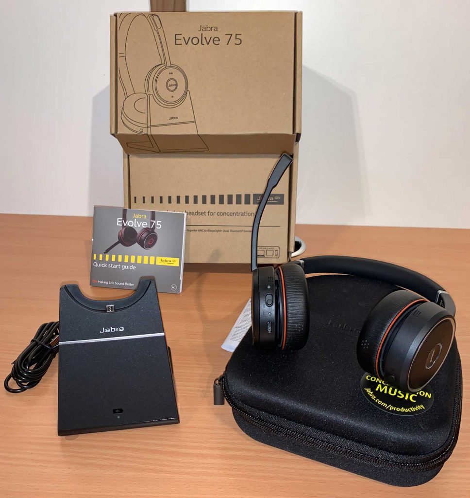Image showing contents of box of Jabra Evolve 75. Charging docks, documentation, headset case and headset itself.